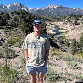 Caden Sajnog hiking in the desert mountains